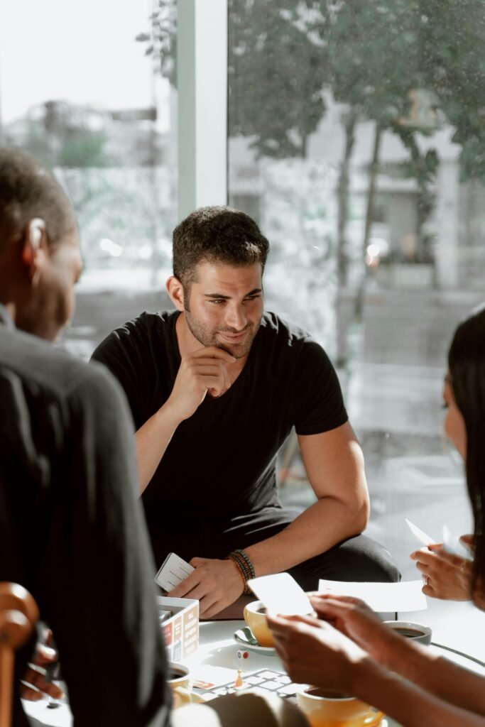pexels-photo-4920896-4920896 Group of adults collaborating during a casual meeting in a bright indoor office setting.