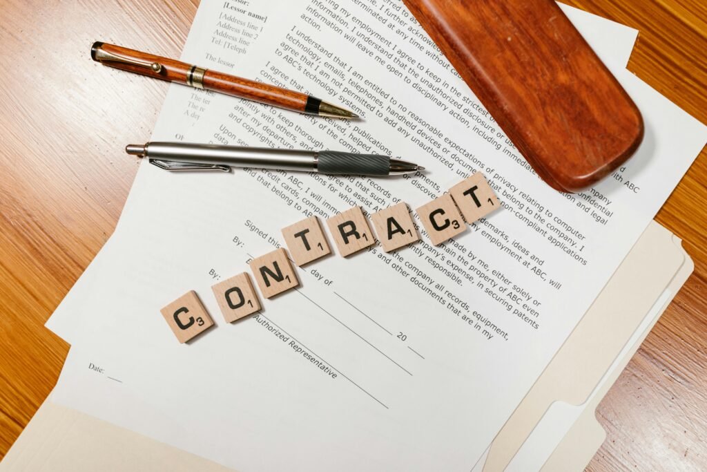 pexels-photo-7841836-7841836 Close-up of contract papers with Scrabble tiles spelling 'CONTRACT'.